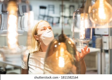 New Normal During Covid Epidemic. Caucasian Woman Shopping At Retail Furniture And Home Accessories Store Wearing Protective Medical Face Mask To Prevent Spreading Of Corona Virus.