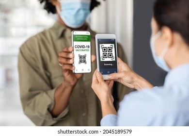 New Normal. Female Worker With Smartphone Scanning Qr Code, Checking Customer's Digital Vaccination Certificate On Entrance To Public Place, Black Man Demonstrating Health Passport In Mobile Phone - Powered by Shutterstock - Get 15% off with code: PIKWIZARD15