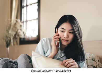 New Normal Lifestyle With Modern Technology Concept. Young Adult Lonely Single Woman Using Smartphone In The Moring For Telemedicine And Mental Health.