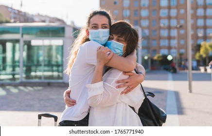 New Normal. Mother And Daughter Embrace Each Other Within The New Normality. Mother And Daughter Hug Each Other With A Mask. Love. Family