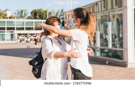 New Normal. Mother And Daughter Embrace Each Other Within The New Normality. Mother And Daughter Hug Each Other With A Mask