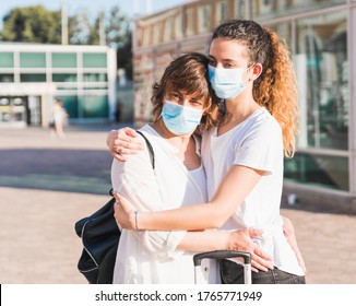 New Normal. Mother And Daughter Embrace Each Other Within The New Normality. Mother And Daughter Hug Each Other With A Mask