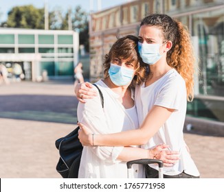 New Normal. Mother And Daughter Embrace Each Other Within The New Normality. Mother And Daughter Hug Each Other With A Mask