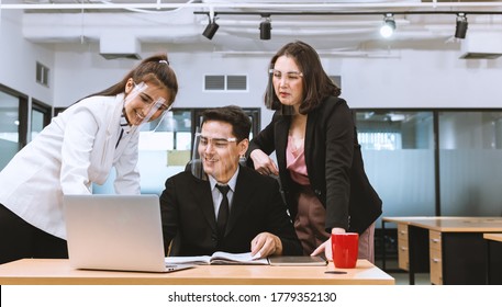 New normal at office. People wearing face mask and Face shield  for prevent covid19 during office time. - Powered by Shutterstock