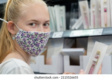 New Normal Retail Shopping. Teenage Blond Girl Wearing Face Mask Choosing Stationery In The Retail Shop. School Supplies. Back To School Shopping