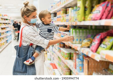 New Normal In Shopping. Young Mother Wearing Prevention Mask And Her Little Son In A Supermarket During Virus Pandemic. 