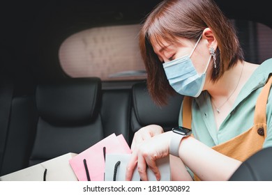 New Normal And Social Distancing Concept With Asian Woman Wear Protective Mask And See Shopping Bag In Her Car