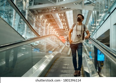 New Normal And Social Distancing Concept.Traveler Business Man Wearing Face Mask And Waiting To Board In To Airplane At Terminal Airport For Protection Coronavirus(covid-19) During Virus Pandemic