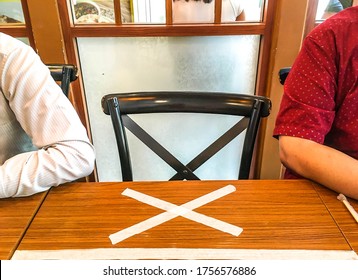 New Normal Of Social Distancing Policy In A Restaurant, Customers Need To Keep Distance From Each Other. No Sitting Sign On Dining Table Between Customers