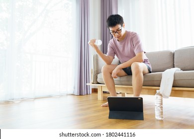 New Normal Training At Home An Asian Man, Aged 35-40, With Brown Skin, Home Exercise. Exercising In Living Room.