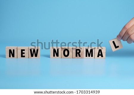 New Normal word on wooden alphabet cube. Concept a new normal life after pandemic.