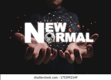 New normal wording on 2 hands. The world is changing to balance it into new normal include business , economy , environment and health. 