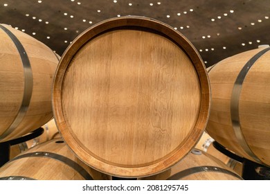 New Oak Barrel With Stainless Steel Rings In A Winery For Making Wine. End View. Advertising, Copy  Space