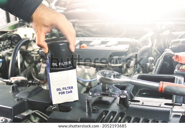 New oil filter\
unbox of the car and oil filter wrench for engine oil system\
maintenance in the repair\
garage