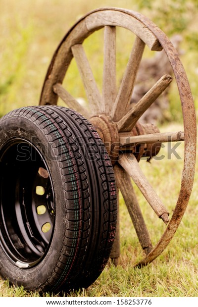 new and old broken wagon\
(car) wheel