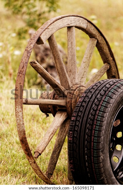 new and old broken wagon\
(car) wheel