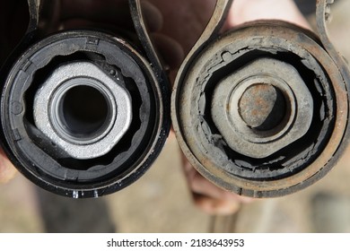 New and old defective silent blocks with metall sleeves close up. Car suspension arm diagnostic service - Shutterstock ID 2183643953