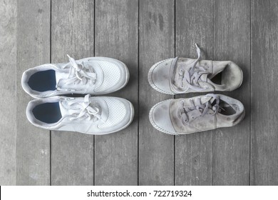 New And Old Dirty White Sneaker Shoes On Gray Wood Floor. Contrast, Comparison, Different, New And Old, Good And Bad, Clean And Dirty, Rich And Poor Concept, Fashion Shoes Background