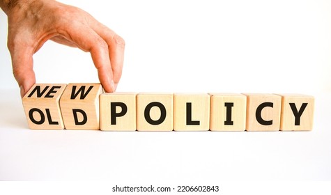 New or old policy symbol. Businessman turns wooden cubes and changes words 'old policy' to 'new policy'. Beautiful white table, white background. Business, old or new policy concept. Copy space.