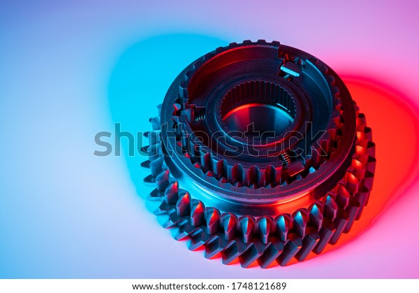 New one metal gears spare parts for gearbox\
in two colors red and blue. Conceptual image of the mechanical\
elements of the\
transmission