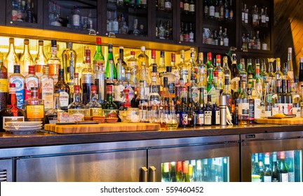 NEW ORLEANS - Dec. 25, 2016: Bar Stocked With Bottles Of Alcohol, Spirits, And Liqueurs. Variety Of Imported And Domestic Labels, Brands And Supplies For Making Cocktails And Drinks.