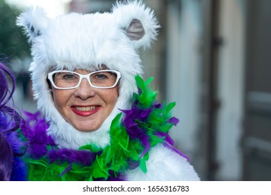 NEW ORLEANS - FEBRUARY 9, 2016: People Enjoy Mardi Gras Parade Wearing Carnival Mask. Mardi Gras Is The Biggest Celebration In The City