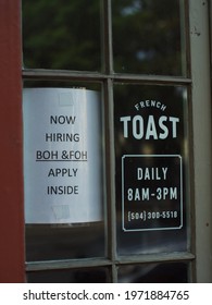 New Orleans, LA - April 19, 2021: A Restaurant Has A Help Wanted Sign In The Window Following The Covid-19 Pandemic.
