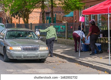 NEW ORLEANS, LA - MARCH 21, 2020: Volunteers Distributing Free Meals To Parents Of School Children Forced To Stay Home Due To Covid-19 Pandemic