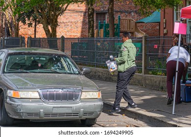 NEW ORLEANS, LA - MARCH 21, 2020: Volunteers Distributing Free Meals To Parents Of School Children Forced To Stay Home Due To Covid-19 Pandemic