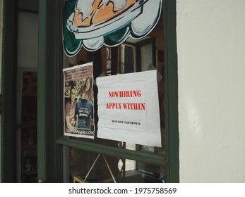 New Orleans, LA - May 16, 2021: A Help Wanted Sign Hangs In A Shop Window In New Orleans