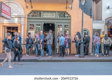 New Orleans, LA - October 30, 2021: People Wait In Line To Enter A Popular Restaurant On Bourbon Street In The French Quarter.