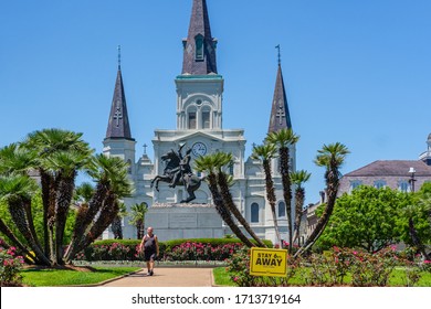 NEW ORLEANS, LA, USA - APRIL 24, 2020: St. Louis Cathedral And Jackson Square During Covid-19 Pandemic With Pedestrian And 