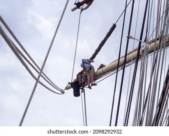 NEW ORLEANS, LA, USA - APRIL 21, 2018: Two crew members working on the main mast of a large sailing ship
