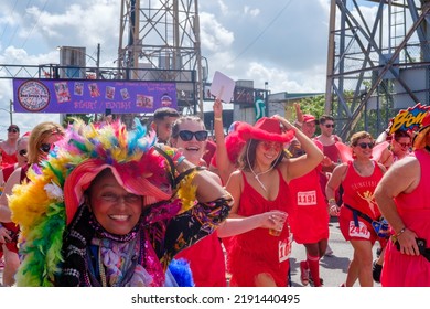 NEW ORLEANS, LA, USA - AUGUST 13, 2022: Colorfully Costumed Walkers Start The Red Dress Run With The Starting Line Behind Them On N. Peters Street In Faubourg Marigny