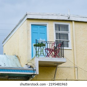 NEW ORLEANS, LA, USA - AUGUST 24, 2022: Table And Two Chairs Set Up On Small Balcony Outside Of And Efficiency Apartment