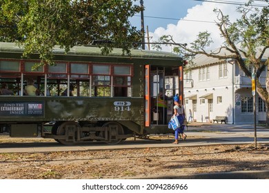 NEW ORLEANS, LA, USA - DECEMBER 18, 2021: Woman Boarding The Streetcar On South Carrollton Avenue