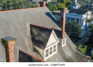 NEW ORLEANS, LA, USA - JANUARY 13, 2022: Aerial View Of Rooftop Of Historic Home In The Garden District Showing Sloped Roof, Vintage Chimneys And Dormer Attic Window