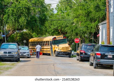 NEW ORLEANS, LA, USA - MAY 9, 2022: School Bus Is Disabled By Pothole In Uptown New Orleans Neighborhood