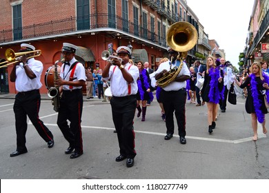 New Orleans, LA, USA October 27 A Band Of Marching Jazz Musicians Form A Second Line Parade As They Lead A Party Crowd Down Bourbon Street In The French Quarter Of New Orleans, Louisiana