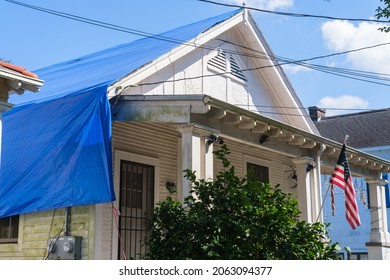 NEW ORLEANS, LA, USA - OCTOBER 22, 2021: Blue Tarp covered roof on house damaged by winds from Hurricane Ida