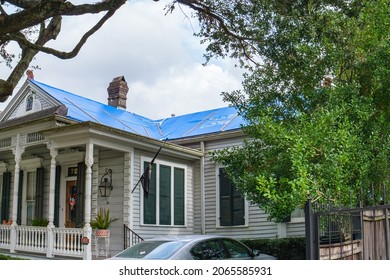 NEW ORLEANS, LA, USA - OCTOBER 27, 2021: Uptown Home With Blue Tarp On Wind Damaged Roof From Hurricane Ida