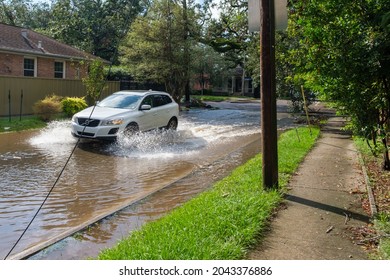 NEW ORLEANS, LA, USA - SEPTEMBER 15, 2021: Car Splashes Through Flooded Street