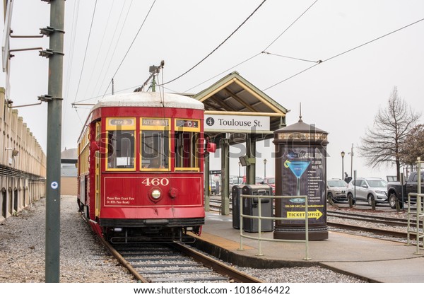 New Orleans,\
LA/USA - Jan. 28, 2018: The iconic New Orleans Street Car\
approaches the Toulouse Station in winter, in the rain. New Orleans\
has historically been a transportation\
hub.