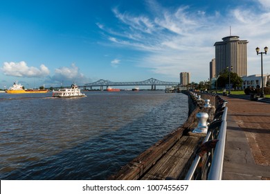 New Orleans, Louisiana - June 17, 2014: View Of The Mississippi River With Boats From The Riverfront, With The Great New Orleans Bridge On The Background In New Orleans, Louisiana,