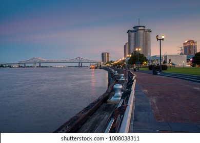 New Orleans, Louisiana - June 17, 2014: View Of The Mississippi River From The City Of New Orleans Riverfront, With The Great New Orleans Bridge On The Background In New Orleans, Louisiana, At Dusk.