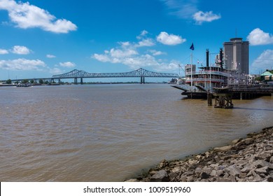 New Orleans, Louisiana - June 17, 2014: View Of The Mississippi With A Mississippi Steamboat And The Great New Orleans Bridge On The Background In New Orleans, Louisiana.