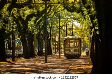 New Orleans, Louisiana - June 18, 2019:  Passengers ride the historic railway streetcar along Saint Charles Avenue in the Garden District of New Orleans Louisiana USA.
