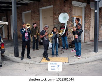 New Orleans, Louisiana, USA - 2019: A Jazz Band Conformed Of Young Men Performs At A Street Corner In The French Quarter To Collect Money For College.