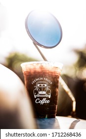 New Orleans, Louisiana / USA - May 3 2019: Close Up Of Clear Plastic Cup Branded With French Truck Coffee. Glass Of Cold Brew And Crushed Ice Sitting On A Vintage Car Hood With Sunlight Pouring In. 