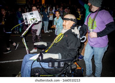 New Orleans, Louisiana/USA - February 21, 2020:  Steve Gleason Rolls With The Krewe Of Muses Down St Charles Avenue For A Mardi Gras Parade In New Orleans, Louisiana.